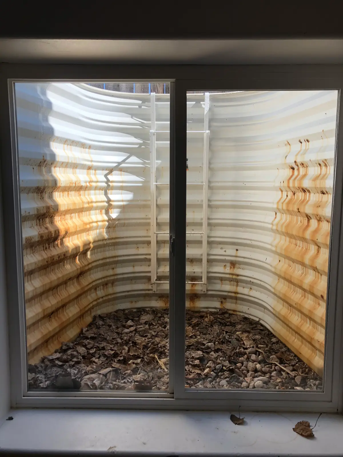 Old rusted window well replacement In Fort Collins, CO