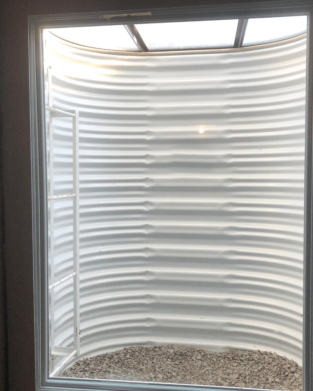 Contractor installing a code-compliant window well for a new home in Fort Collins, CO